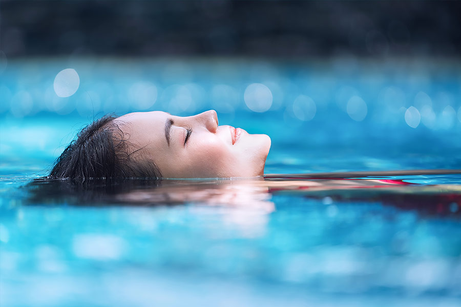 Woman Relaxing in Swimming Pool