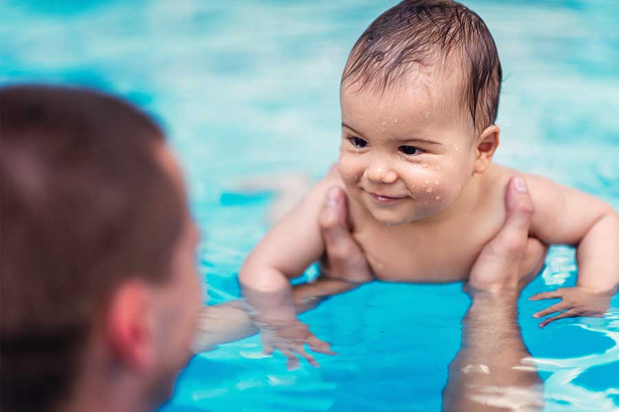 Father and baby swimming