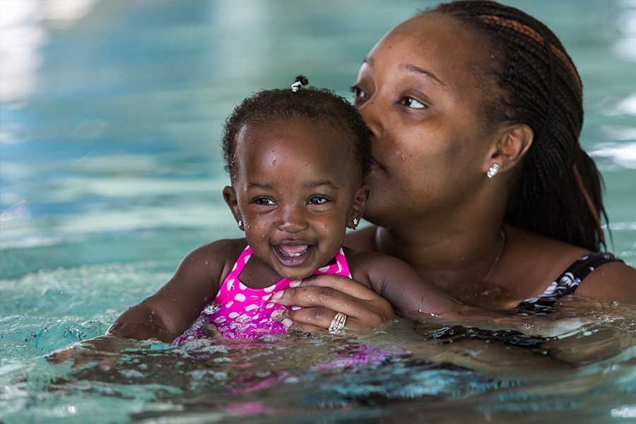 Mother and baby swimming lesson