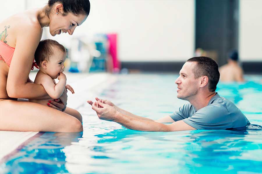 Family swimming with baby