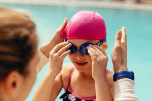 Girl putting on goggles